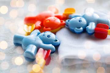 Image showing close up of baby rattle and clothes for newborn