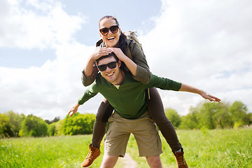 Image showing happy couple with backpacks having fun outdoors