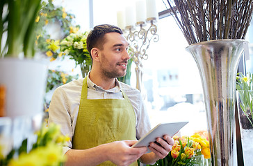 Image showing man with tablet pc computer at flower shop