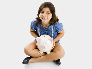 Image showing Young girl holding a piggybank