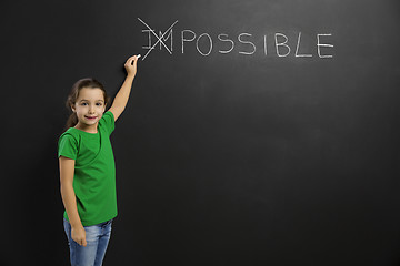 Image showing Girl writing in a blackboard