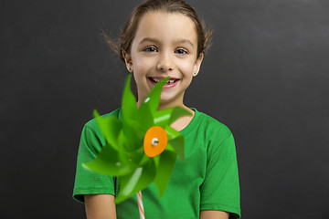 Image showing Little girl holding a windmill