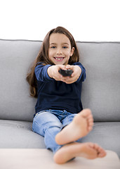 Image showing Girl holding a TV remote