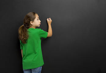 Image showing Girl writing in a blackboard