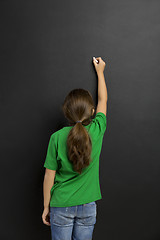 Image showing Girl writing in a blackboard