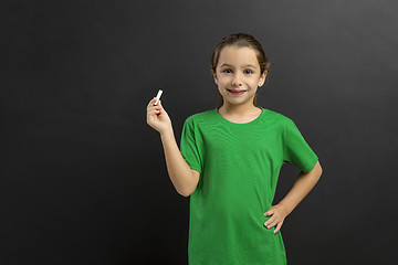 Image showing Girl writing in a blackboard