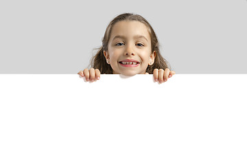 Image showing Cute girl holding a blankboard