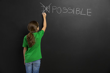 Image showing Girl writing in a blackboard