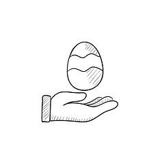 Image showing Hand holding easter egg sketch icon.