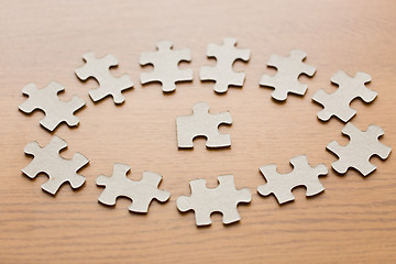 Image showing close up of puzzle pieces on wooden surface