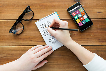 Image showing close up of woman or student writing to notepad