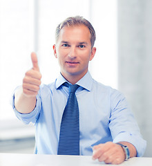 Image showing smiling businessman showing thumbs up