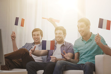 Image showing happy male friends with flags and vuvuzela