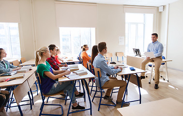 Image showing group of students and teacher with papers or tests