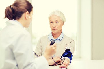 Image showing doctor with tonometer and senior woman at hospital