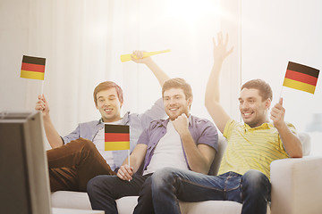 Image showing happy male friends with flags and vuvuzela