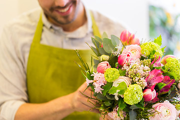 Image showing close up of florist man with bunch at flower shop