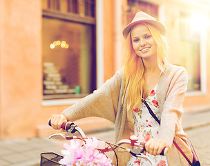 Image showing attractive woman with bicycle in the city