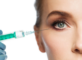 Image showing woman face and hand with syringe making injection