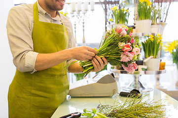 Image showing close up of florist man with bunch at flower shop