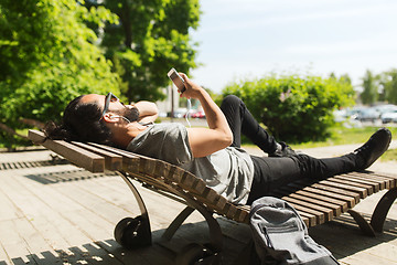 Image showing man with smartphone and earphones listening music