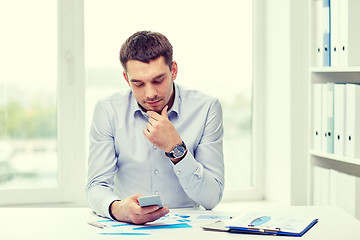 Image showing close up of businessman with smartphone