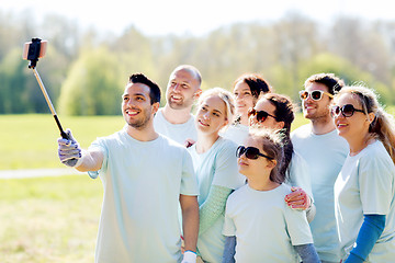 Image showing group of volunteers taking smartphone selfie