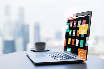 Image showing close up of laptop and coffee cup on office table