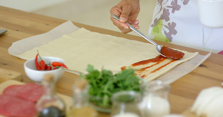 Image showing Woman preparing traditional homemade pizza