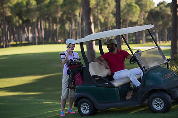 Image showing couple in buggy on golf course