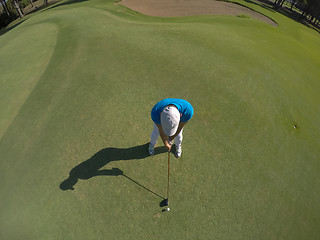 Image showing top view of golf player hitting shot