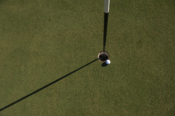 Image showing top view of golf ball in the hole