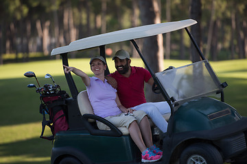 Image showing couple in buggy on golf course