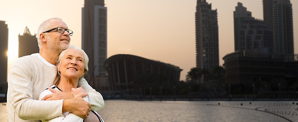 Image showing senior couple hugging over dubai city background