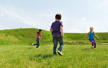 Image showing group of happy kids running outdoors