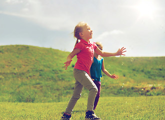 Image showing group of happy kids running outdoors