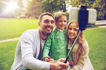 Image showing happy family taking selfie by smartphone outdoors