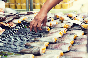 Image showing close up of hand taking fish at street market