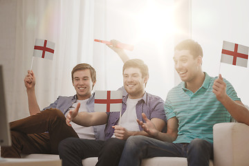 Image showing happy male friends with flags and vuvuzela