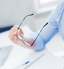 Image showing businessman holding glasses