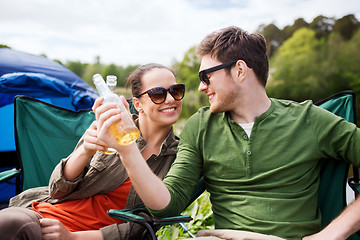 Image showing happy couple clinking drinks at campsite tent