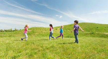 Image showing group of happy kids running outdoors