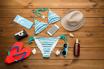 Image showing close up of smartphone and beach stuff