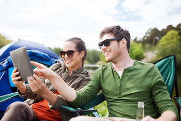 Image showing happy couple with tablet pc at camping tent