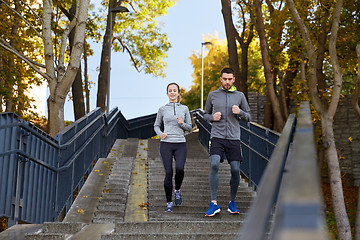 Image showing happy couple running downstairs in city