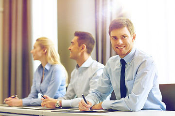 Image showing group of smiling businesspeople meeting in office