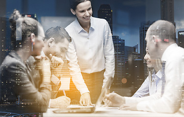 Image showing smiling female boss talking to business team