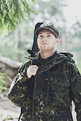 Image showing young soldier or hunter with gun in forest