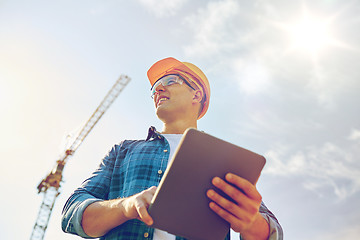 Image showing builder in hardhat with tablet pc at construction