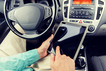 Image showing close up of young man with tablet pc driving car